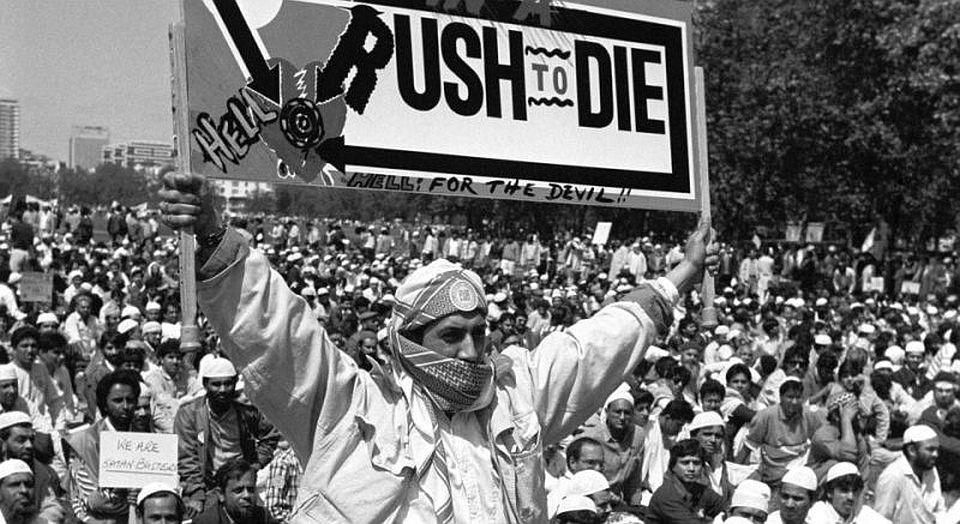 A protester hods aloft a banner in Hyde park, during a protest against Satanic Verses author Salman Rushdie, 28 May 1989.