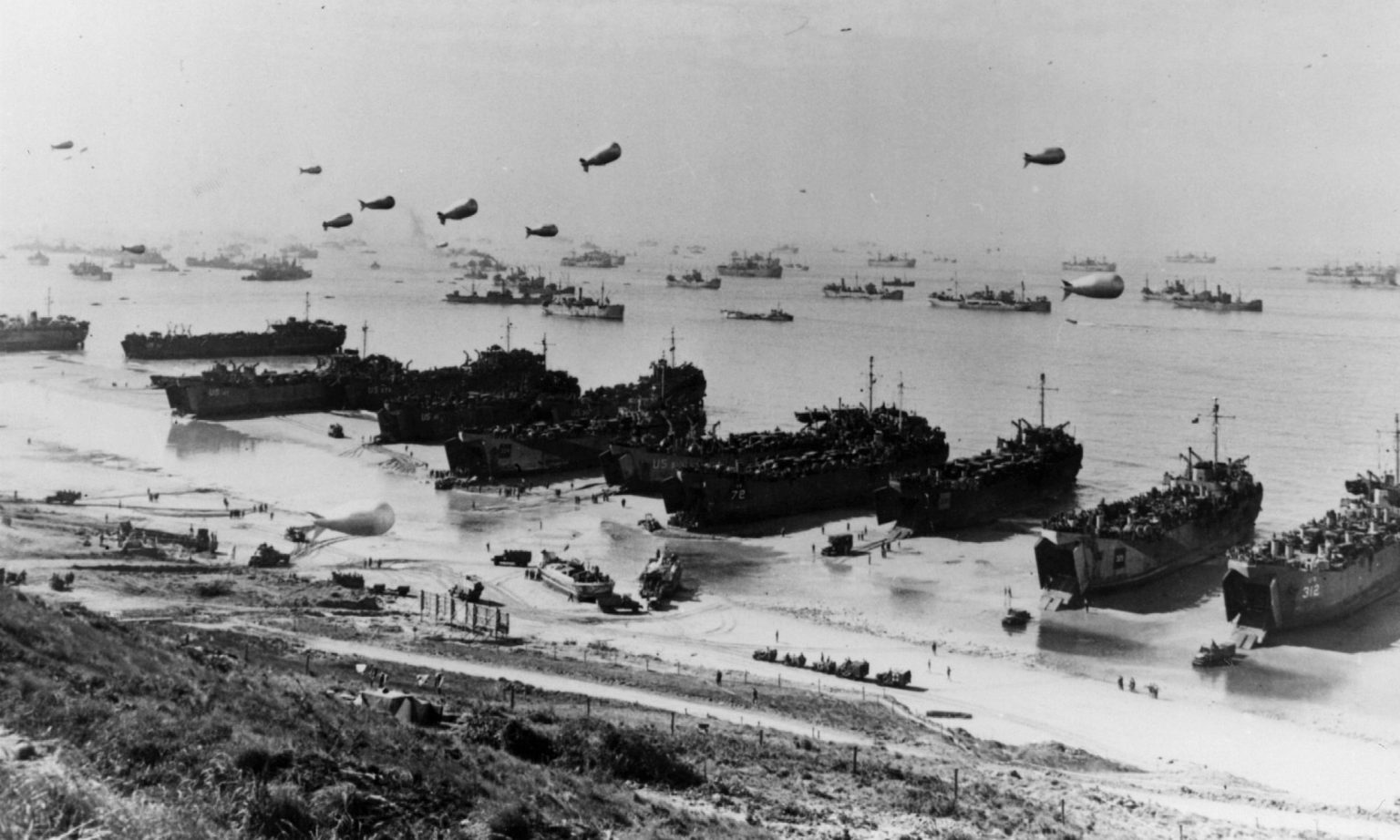Barrage balloons and shipping at Omaha Beach during the Allied amphibious assault. (Photo by Three Lions/Getty Images)