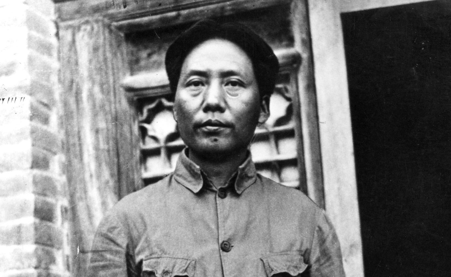 Mao Zedong stands outside the Kangdah Cave University during the Second Sino-Japanese War, 1938.