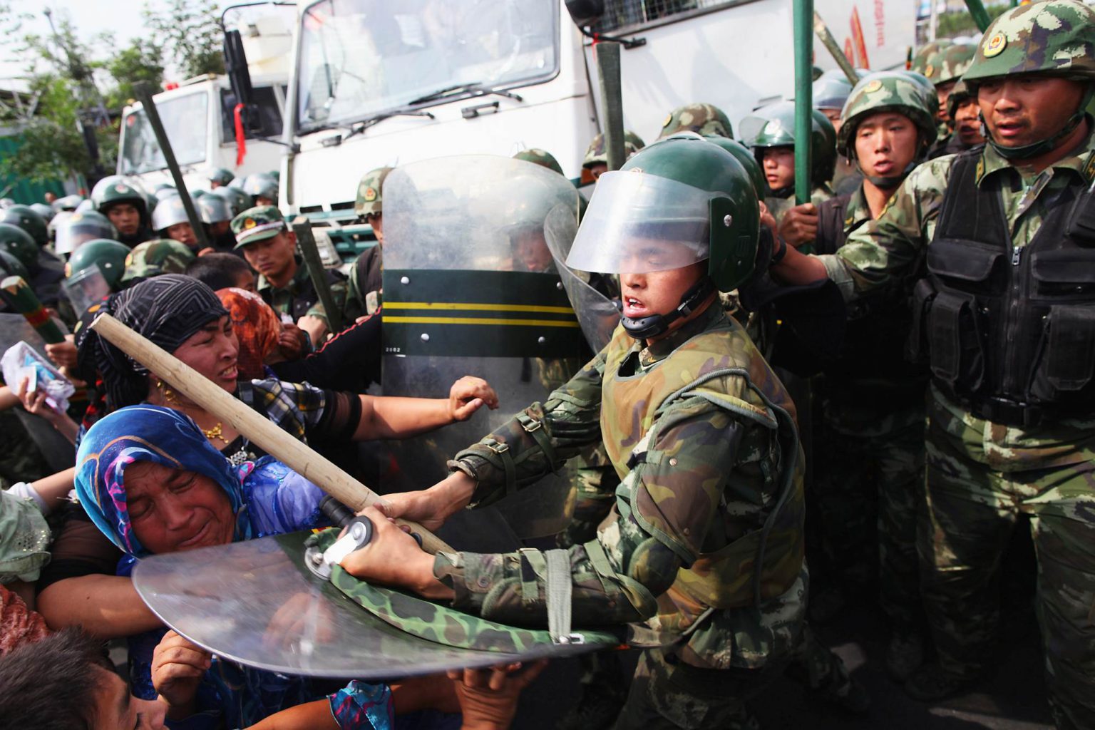Chinese policemen push Uighur women protesting in Urumqi, the capital of Xinjiang Uighur autonomous region, 7 July 2009.