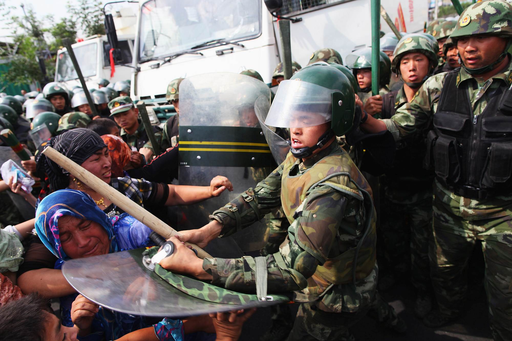 Chinese policemen push Uighur women protesting in Urumqi, the capital of Xinjiang Uighur autonomous region, 7 July 2009.