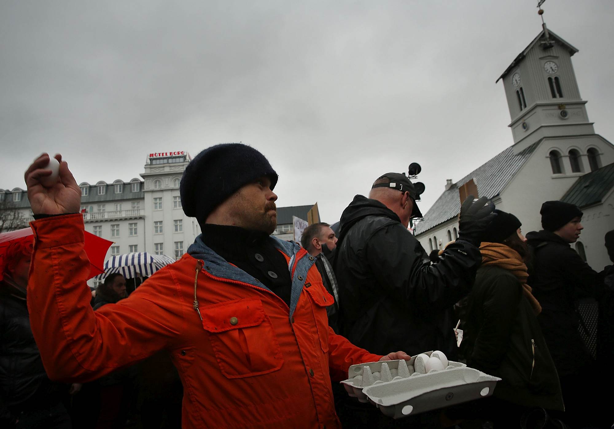 A protester throws an egg at the parliament building in Reykjavik.