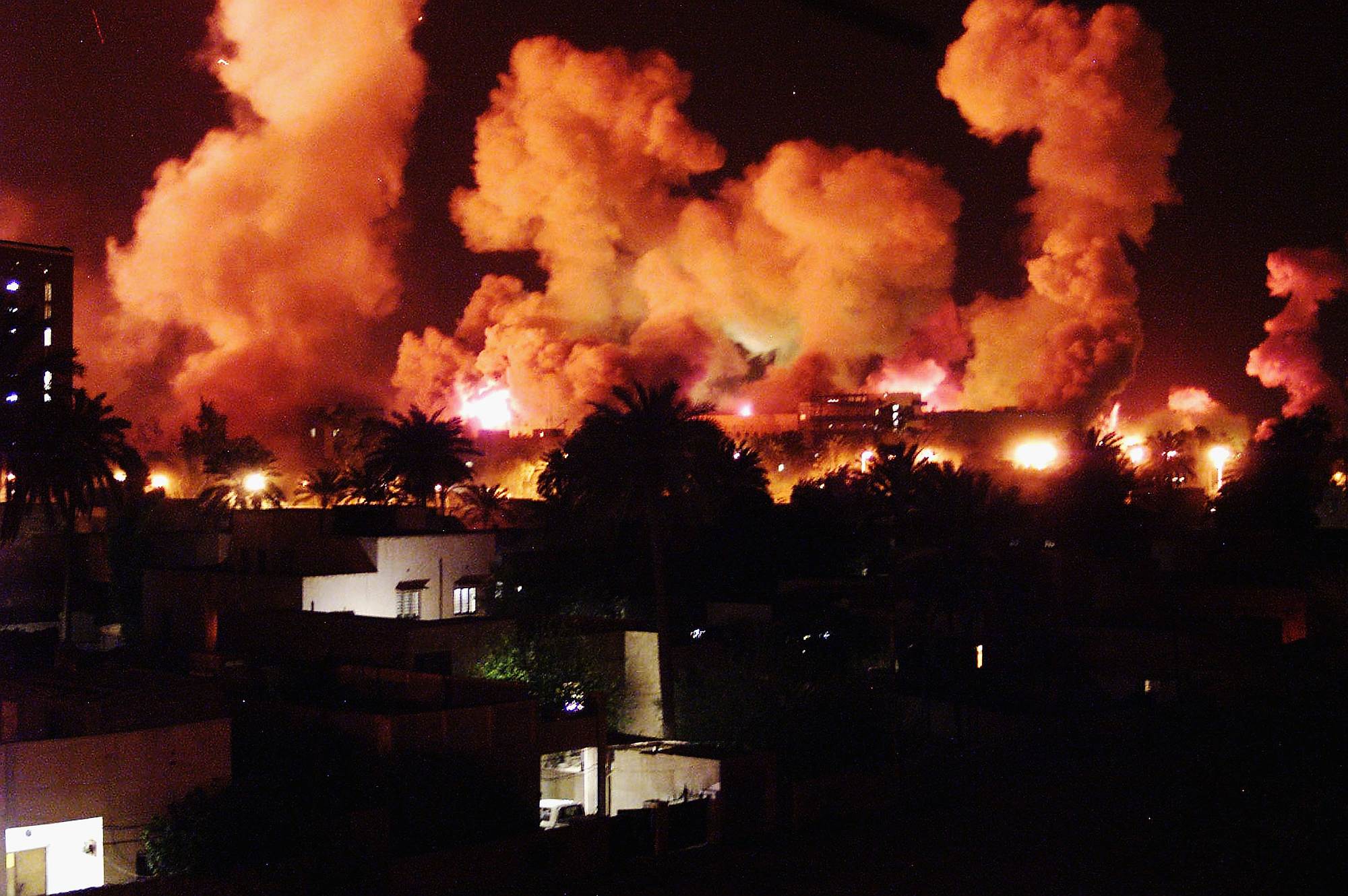 Smoke rises from explosions during the first few minutes of an air attack on Baghdad, Iraq, 21 March 2003.