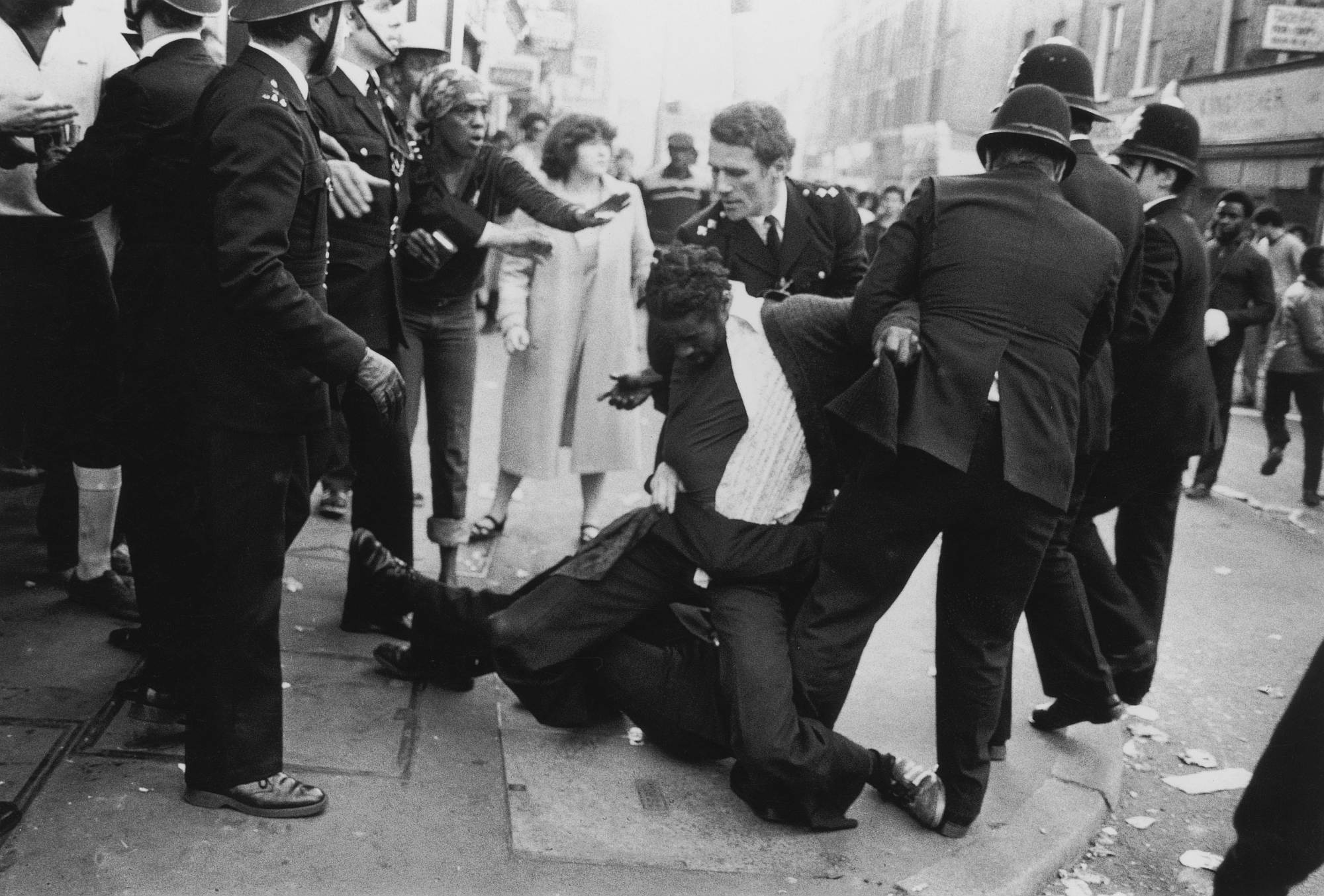 Police officers make an arrest on the second day of riots in Brixton, 13 April 1981.