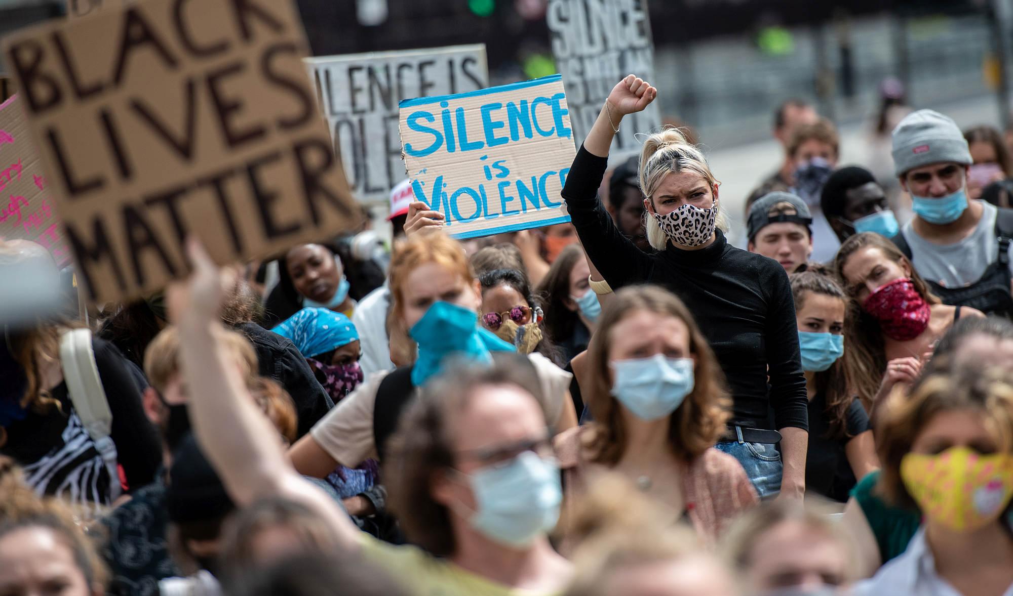 Protesters hold placards in Parliament Square during a demonstration on 20 June 2020 in London.
