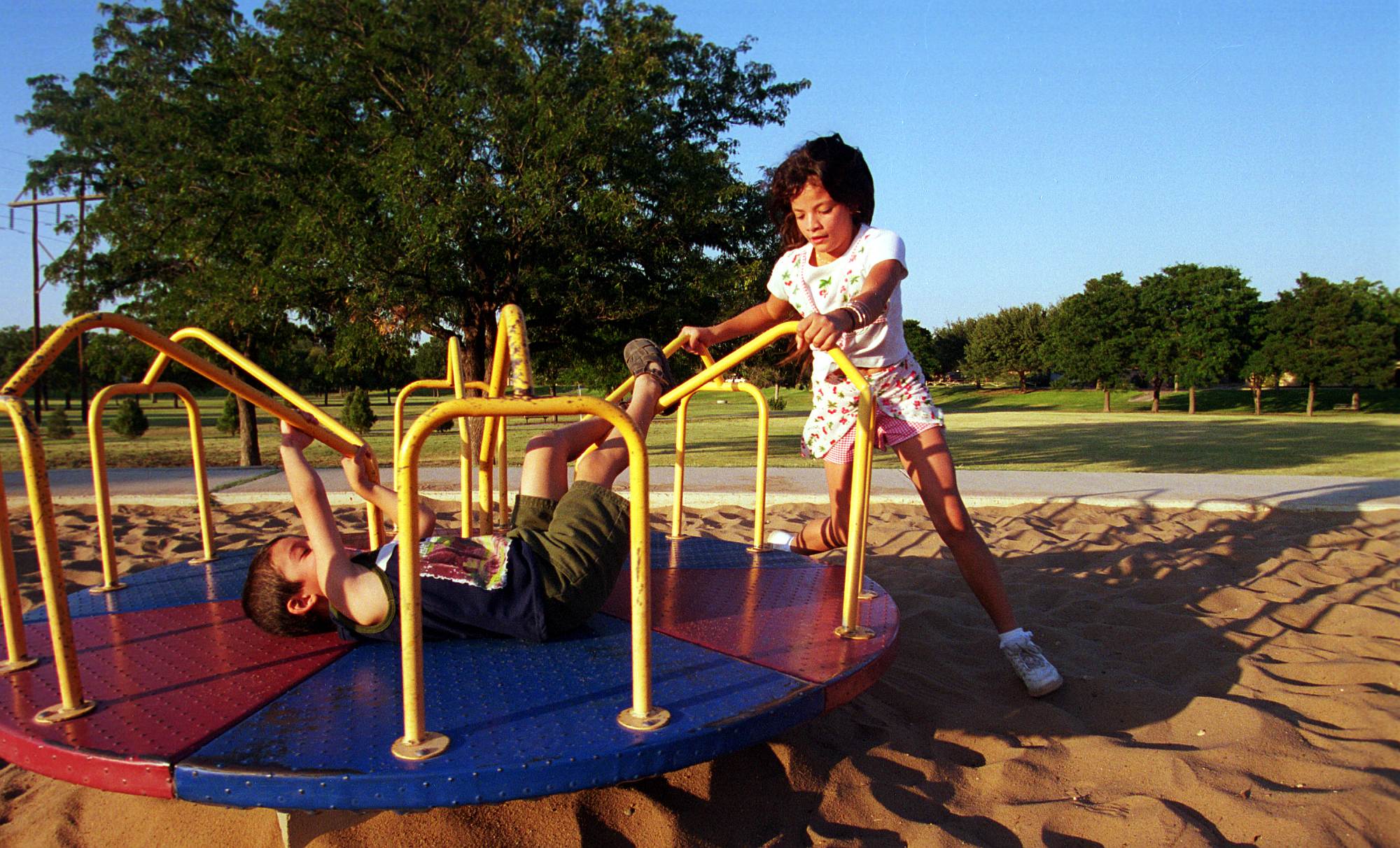 Children in Midland, Texas play in Cowden Park, 4 September 2000.