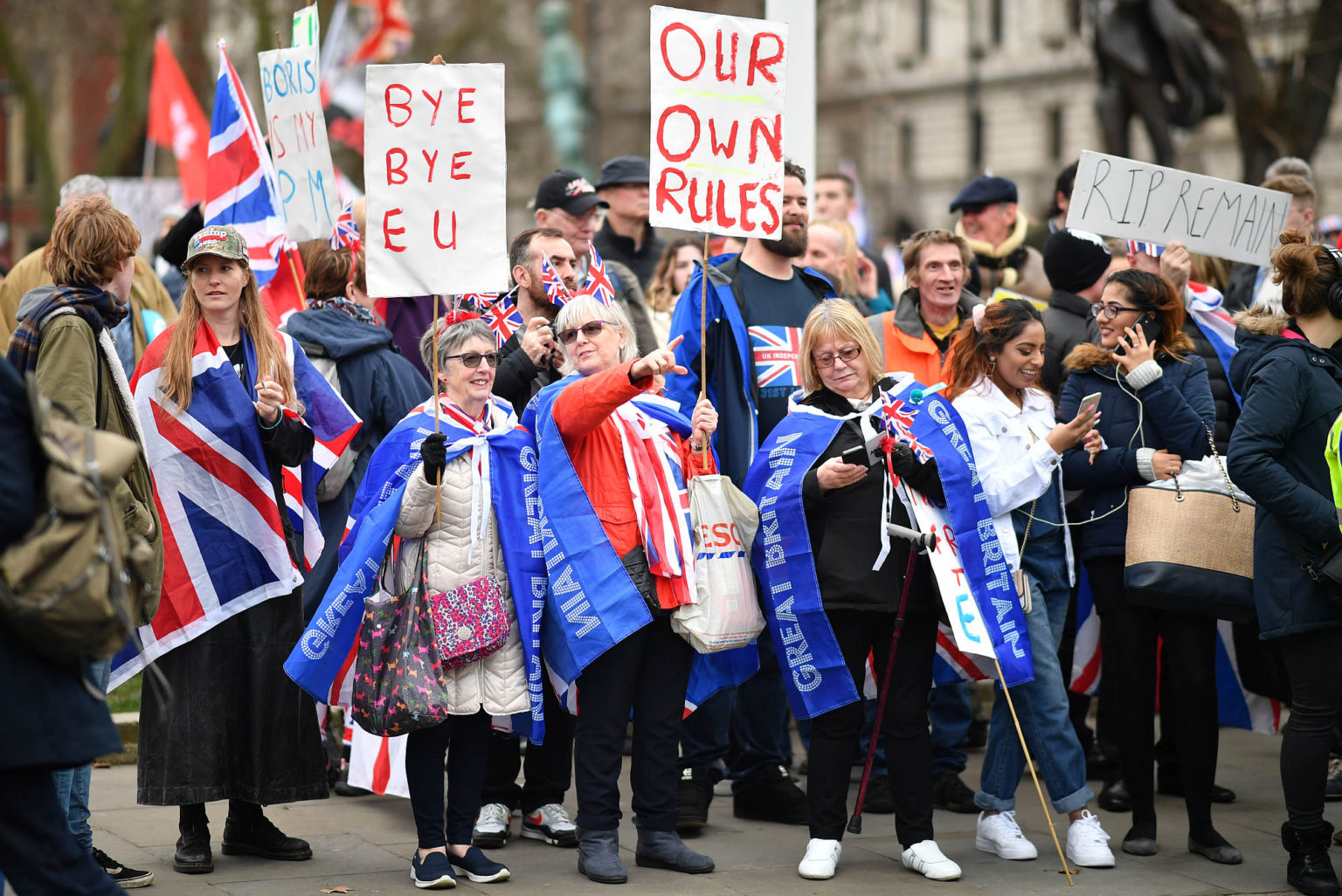 Brexit supporters wave placards at Parliament Square, London, 31 January 2020.