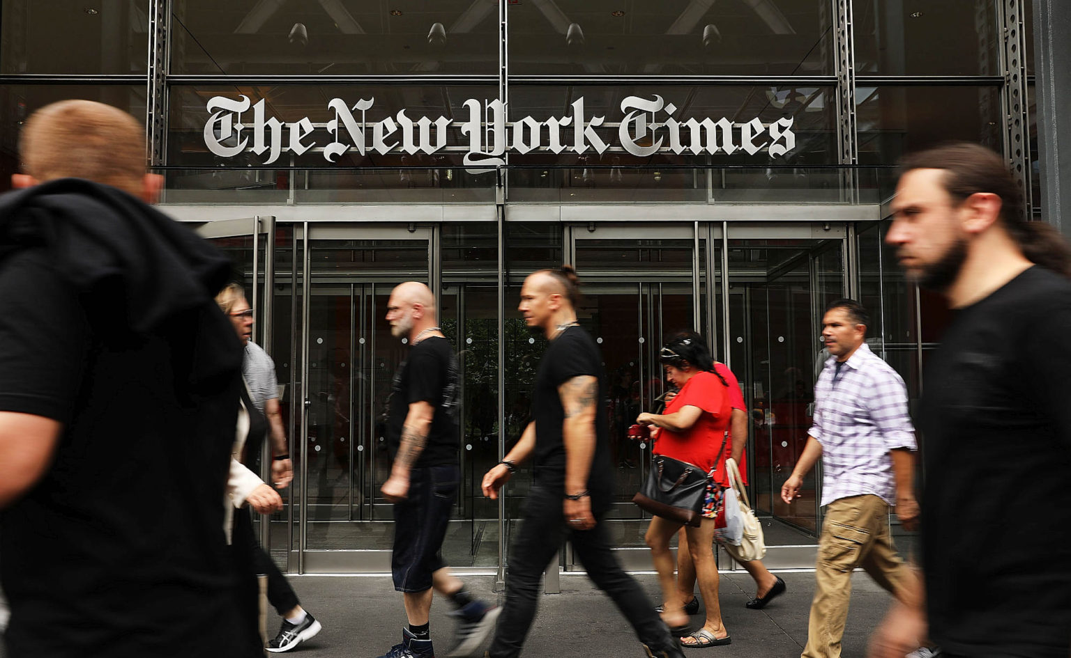 People walk past the New York Times building on 27 July, 2017, in New York City.