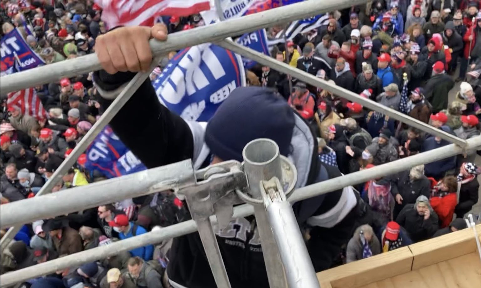 A man scales the northwest bleacher scaffolding outside the Capitol. Washington, DC, 6 January, 2021. Washington, DC.