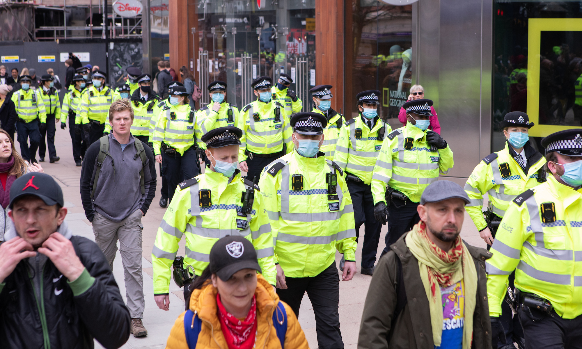 Officers follow the demonstrators down Oxford Street.