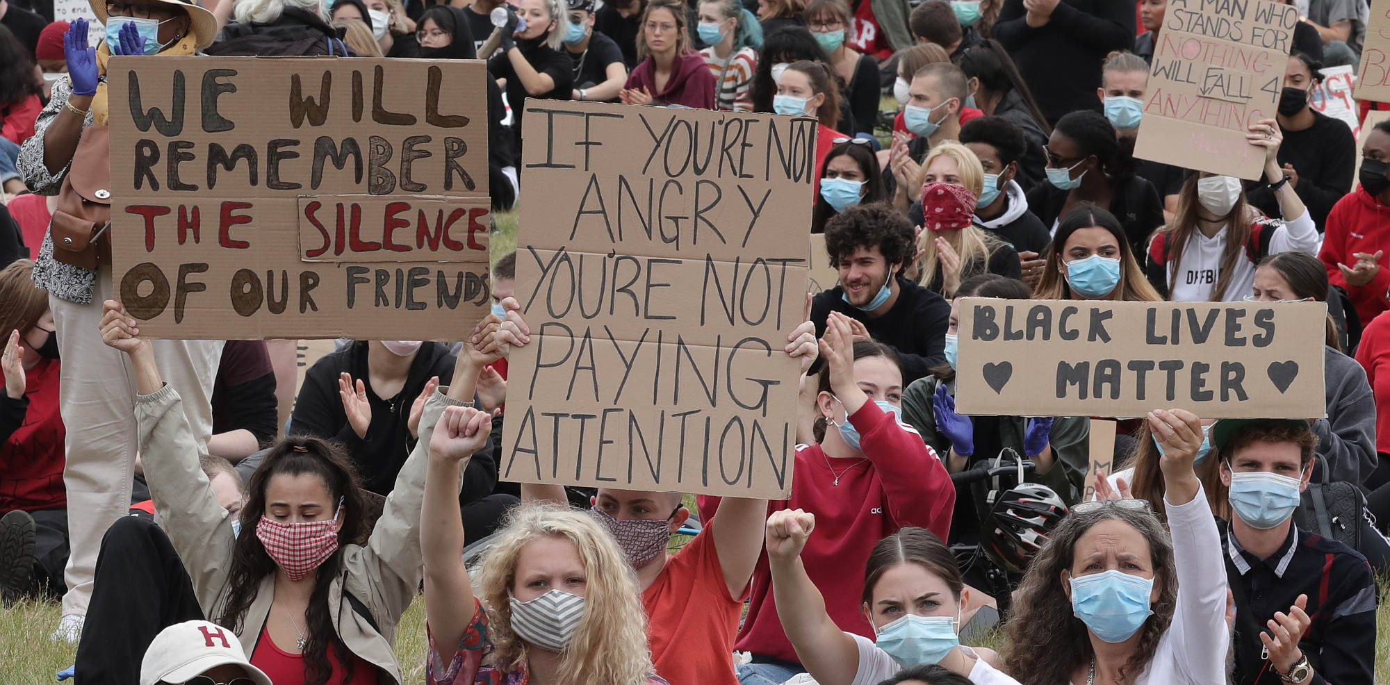 Protesters hold up signs during a Black Lives Matter protest in Hyde Park, London, on 3 June 2020.