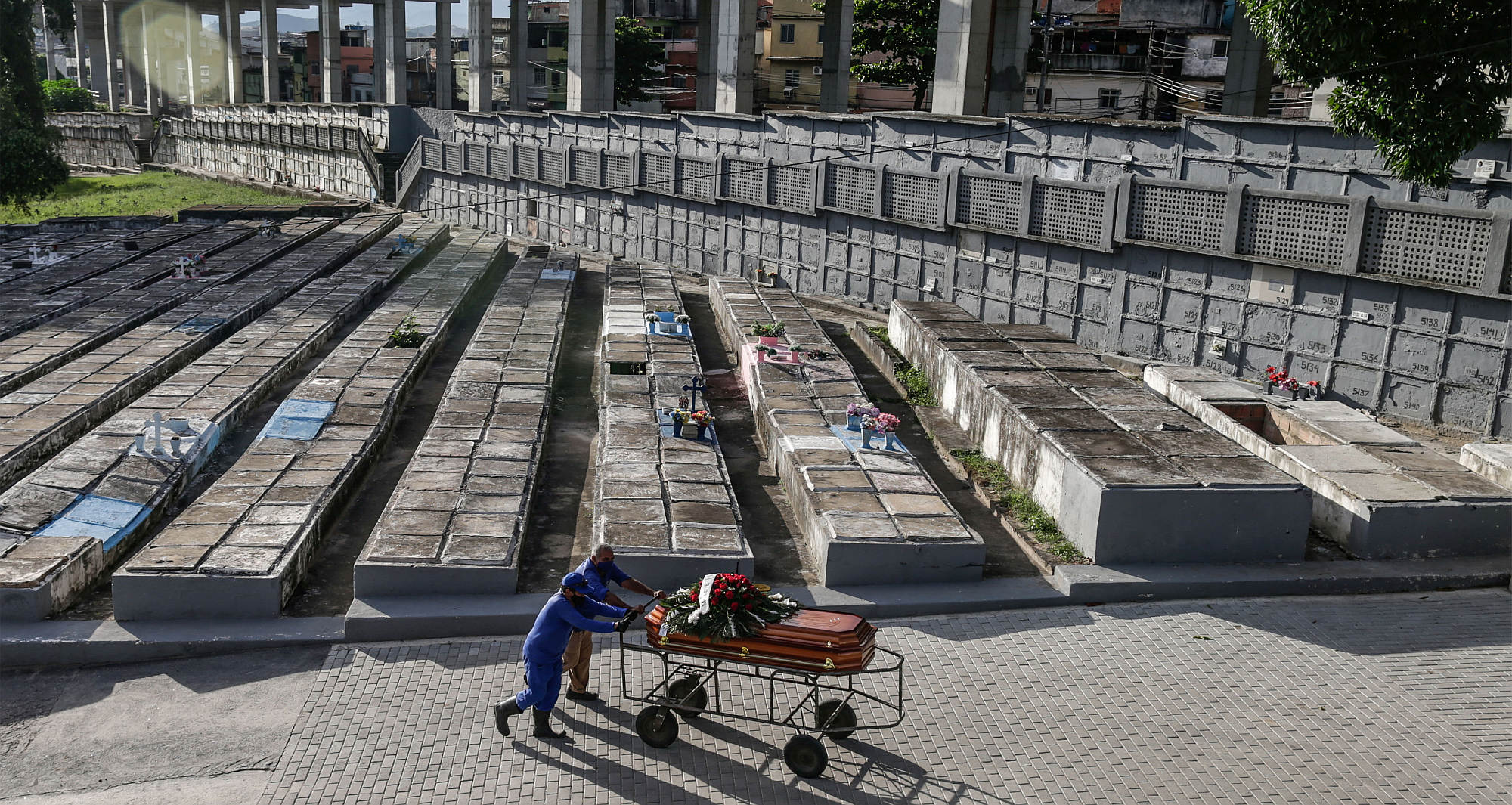 Gravediggers carry a coffin of a Covid-19 victim at the Sao Francisco Xavier cemetery, Rio de Janeiro, on 7 January 2021.