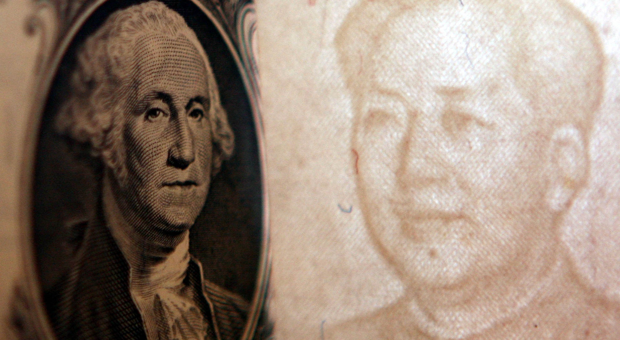 Details of dollar and a yuan notes are seen at a bank on 15 May 2006, Beijing, China.