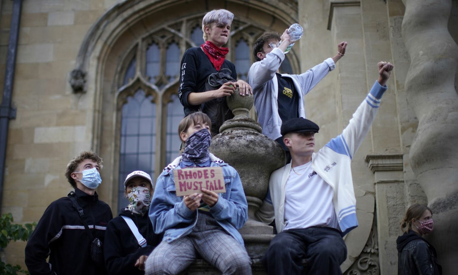 Demonstrators gather outside Oriel College, Oxford during a protest over a statue of Cecil Rhodes which overlooks the High Street, on 9 June, 2020.