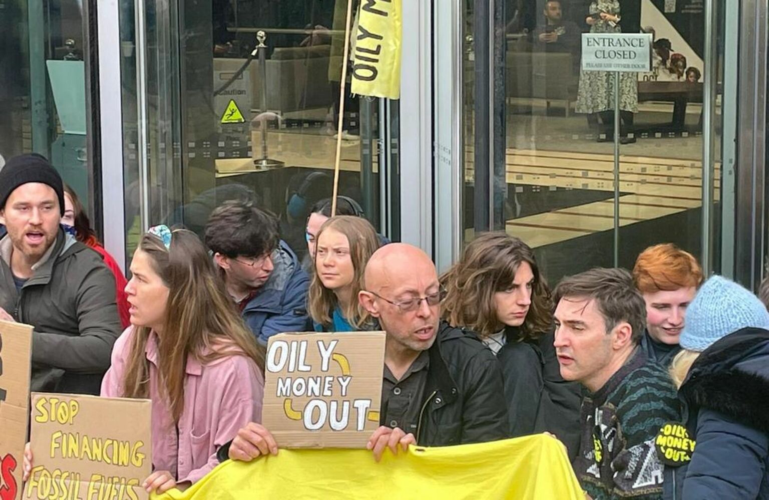 Greta Thunberg shielded by fellow protesters outside JP Morgan's headquarters in Canary Wharf, October 19 2023.