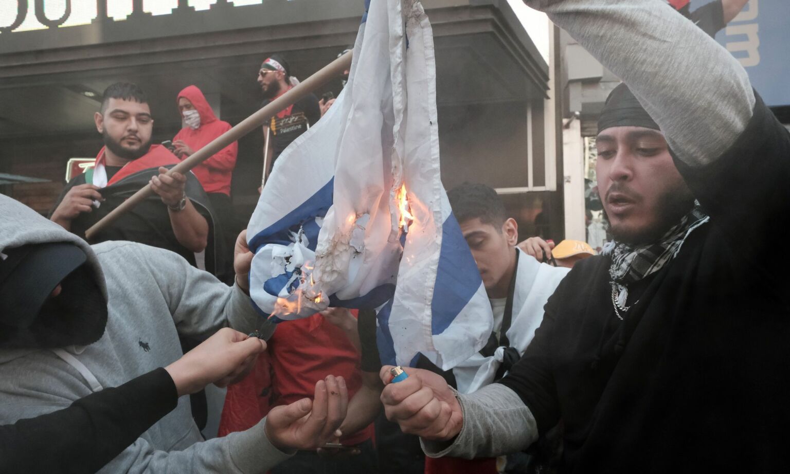 Palestinian protestors burning an Israeli flag during a clash with Israeli protestors at Times Square, New York City in 2021.