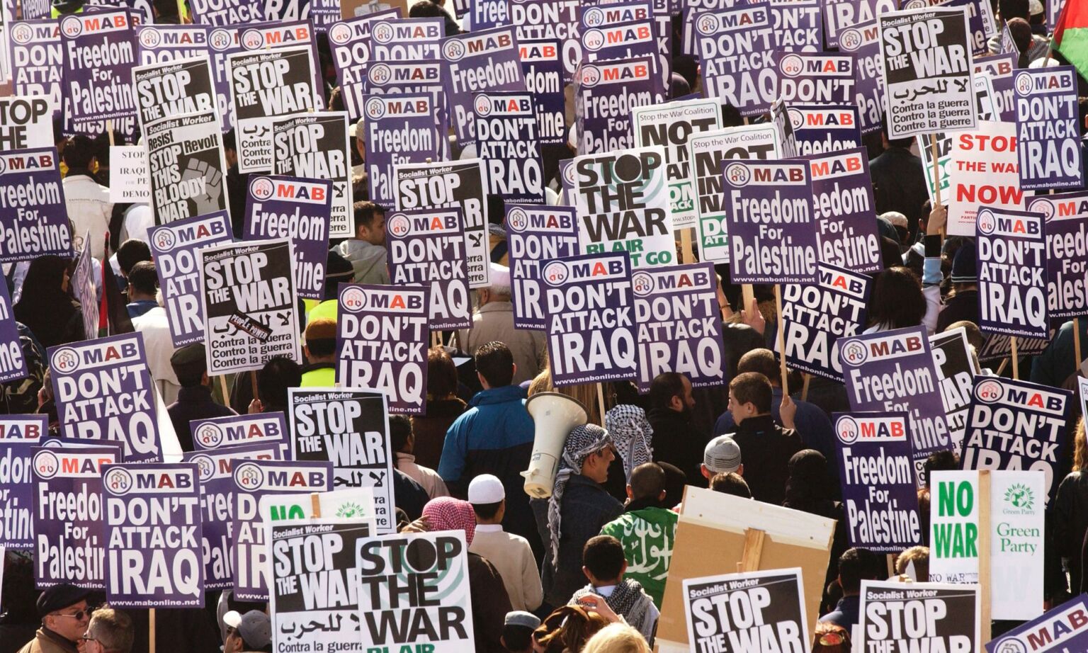 Antiwar demonstrators hold banners while marching March 21, 2003 in London, England.
