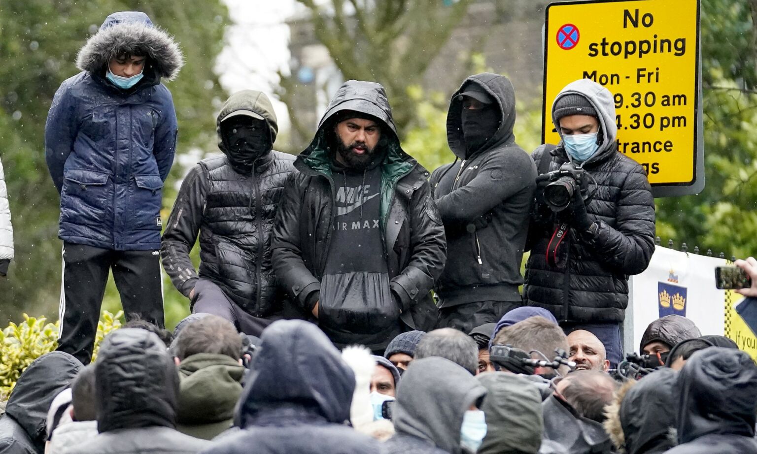 Protesters gather outside the gates of Batley Grammar School, after a teacher was suspended for showing an image of the Prophet Muhammad in class, 26 March 2021.