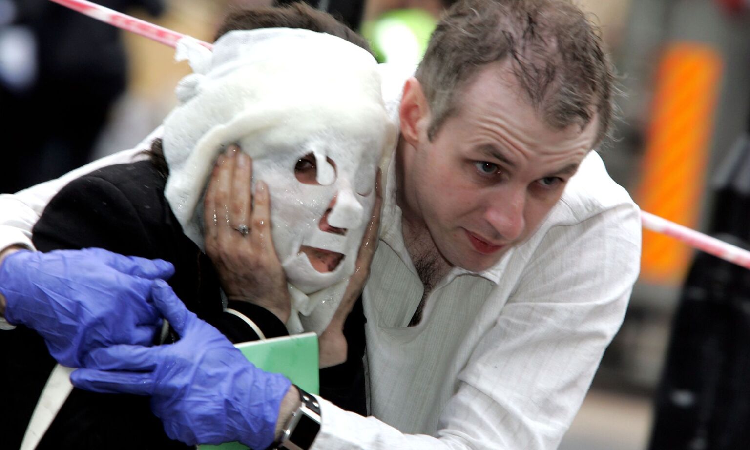 Paul Dadge helps Davinia Turrell 24 to safety at Edgware Road station following a series of explosions, 7 July 2005.