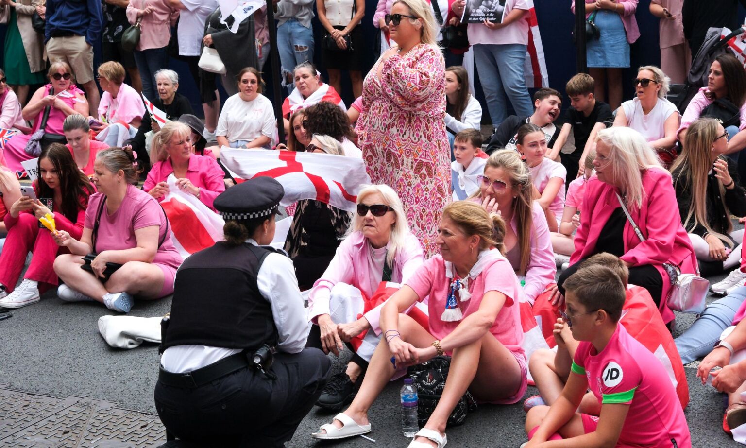 'Pink lady' protesters gather outside the Britannia International Hotel in Canary Wharf, 15 August 2025.