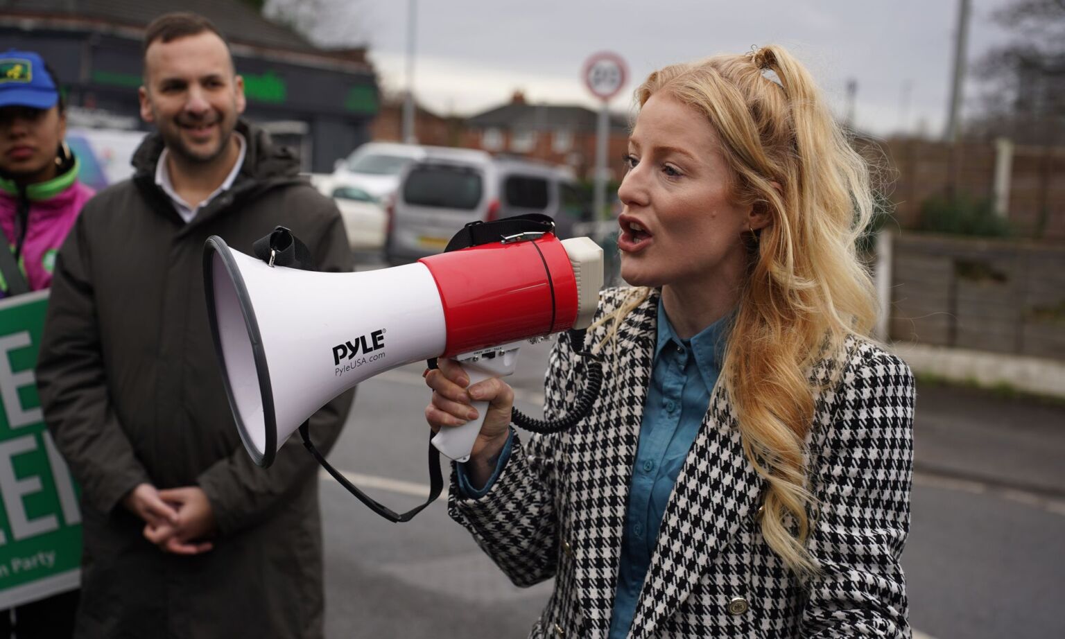 Green Party leader Zack Polanski and Green Party candidate Hannah Spencer talk with supporters outside their campaign headquarters.