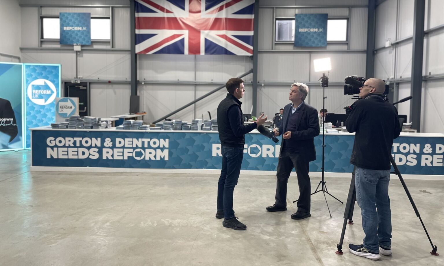 Reform UK candidate Matt Goodwin is interviewd by the media in his party's campaign HQ.