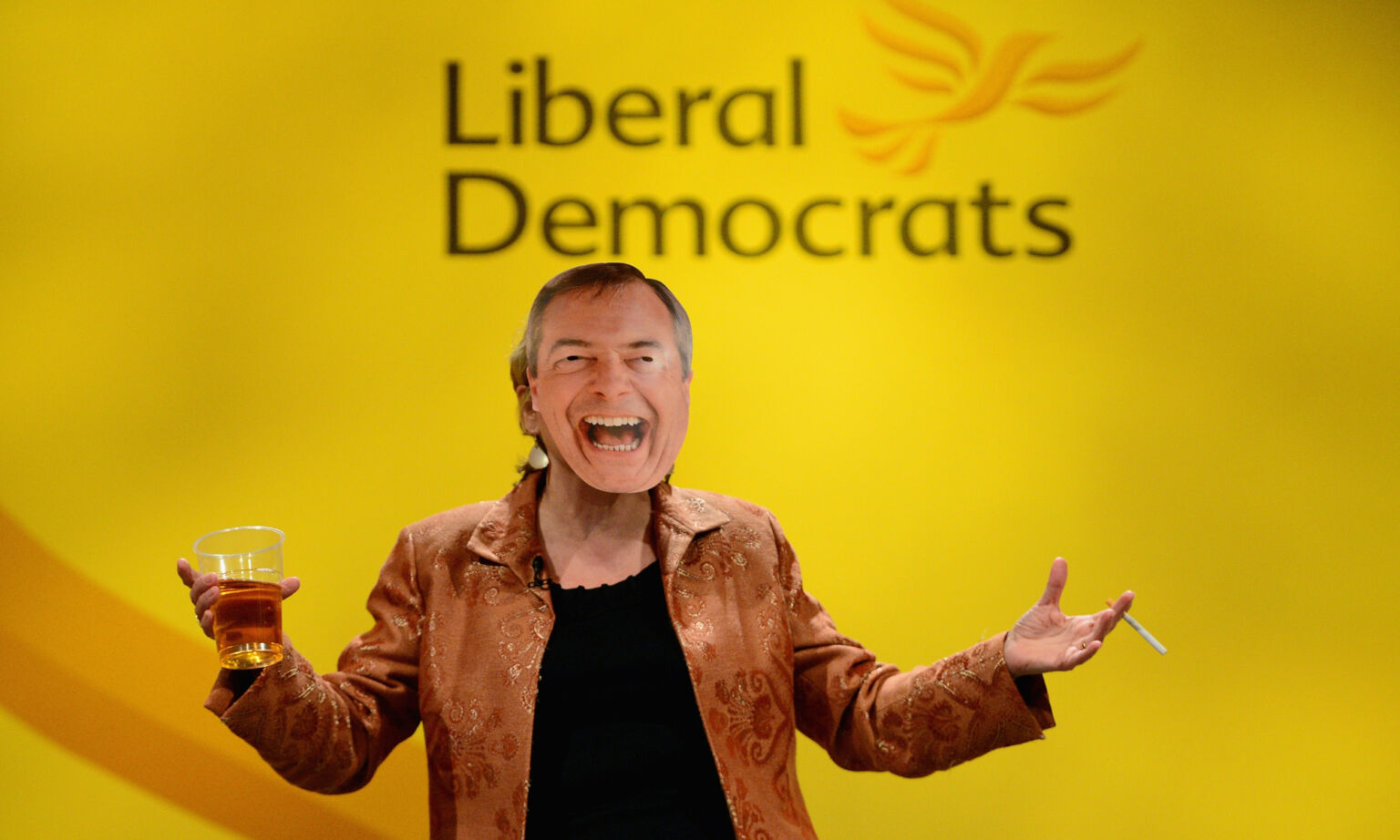 A Lib Dem MP wears a Nigel Farage mask at the party’s spring conference, 9 March 2014. 