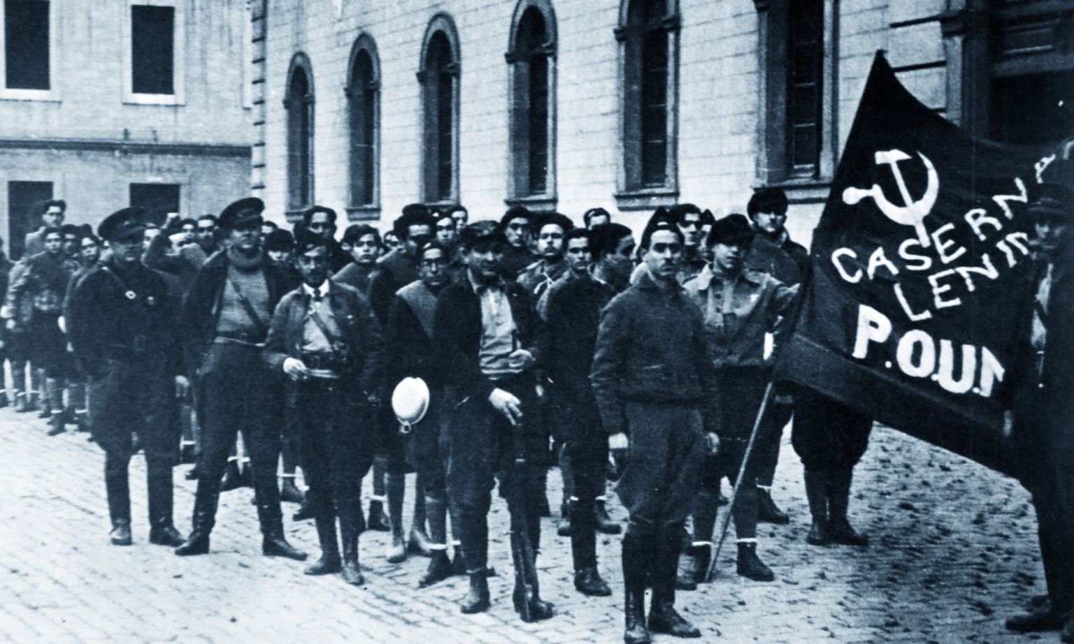 Militants from POUM guard the group's headquarters in Barcelona 1936. The tall figure of George Orwell can be seen right at the back.