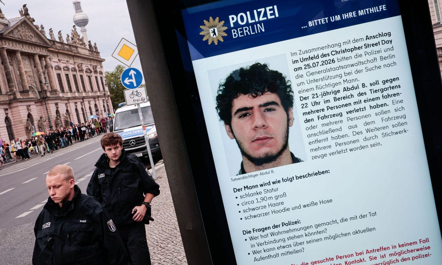 A public information screen displays a Berlin police appeal for information about Abdul Ballout.