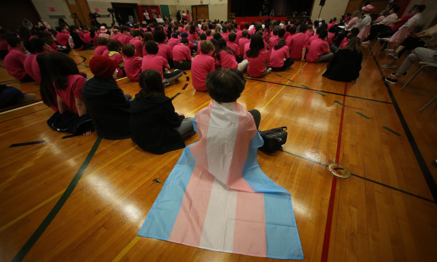 A student wears a trans flag during an assembly at Bowmore Road Junior and Senior Public School, Toronto, 13 April 2022.